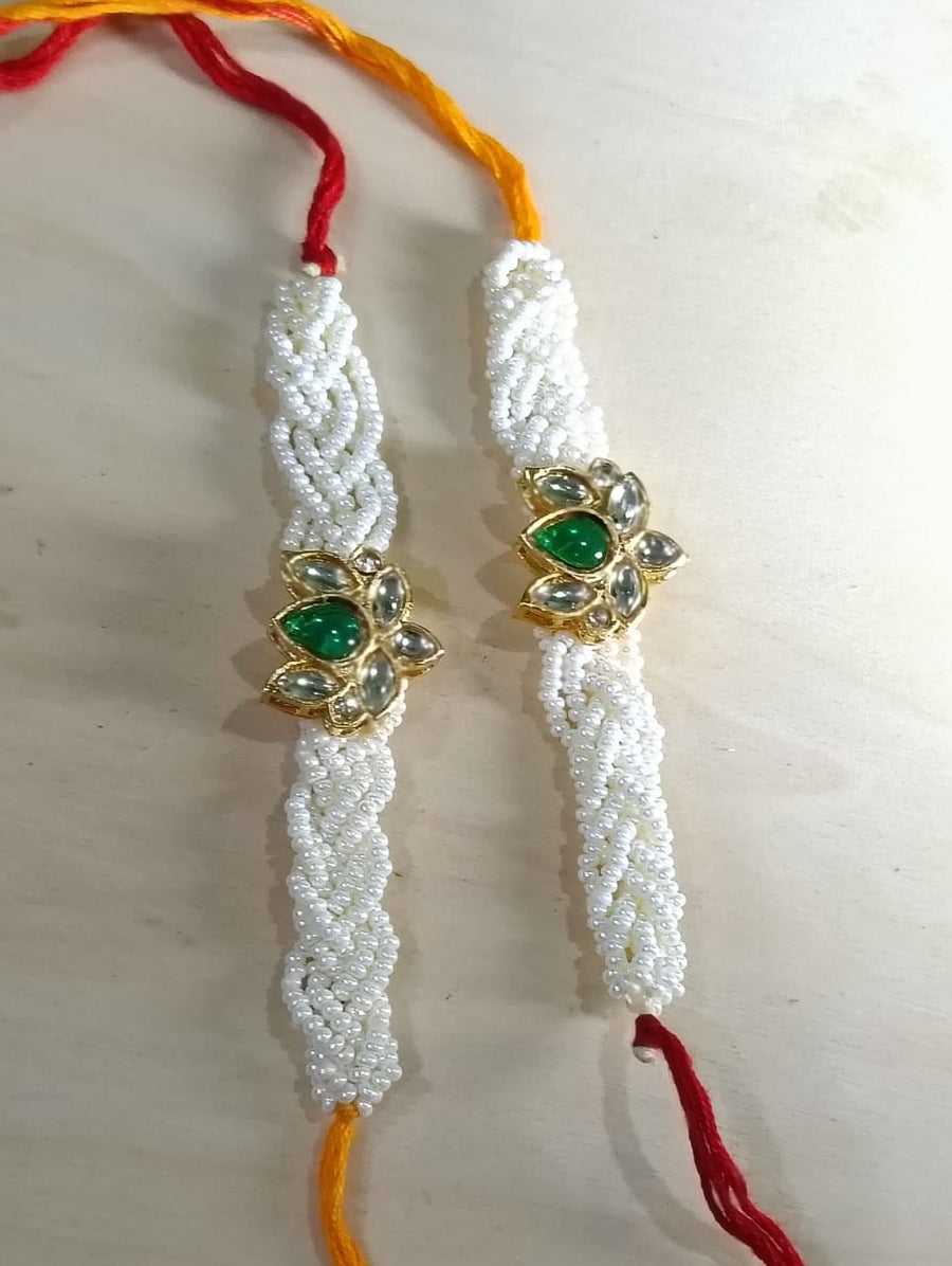 Handcrafted Pearl Rakhi with Green Kundan Floral Center (Set of 2)